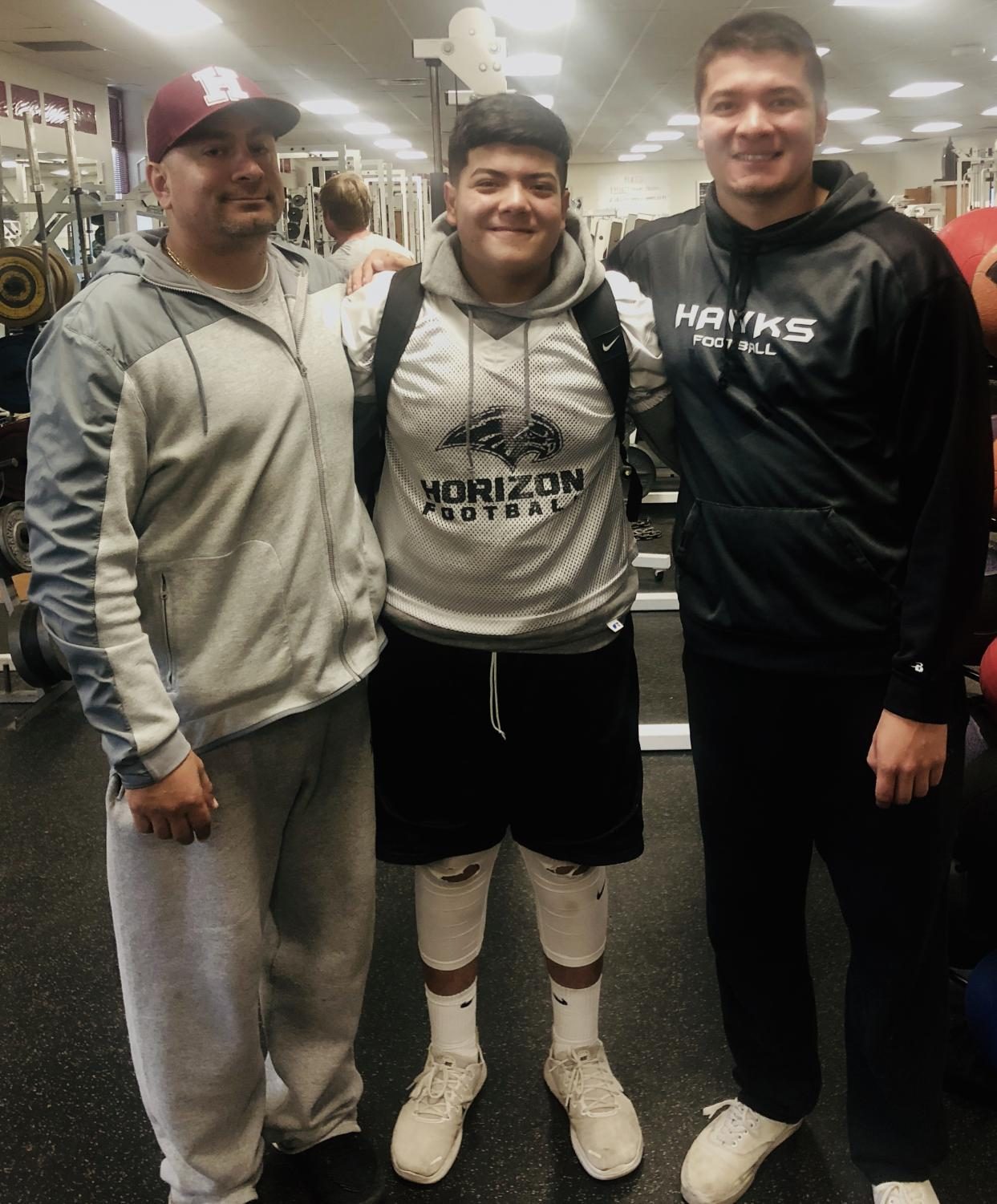 (from left to right) Coach Toledo, father of both boys, Trey Toledo, sophomore, and Art Toledo, Trey’s older brother, all pictured together after football one day