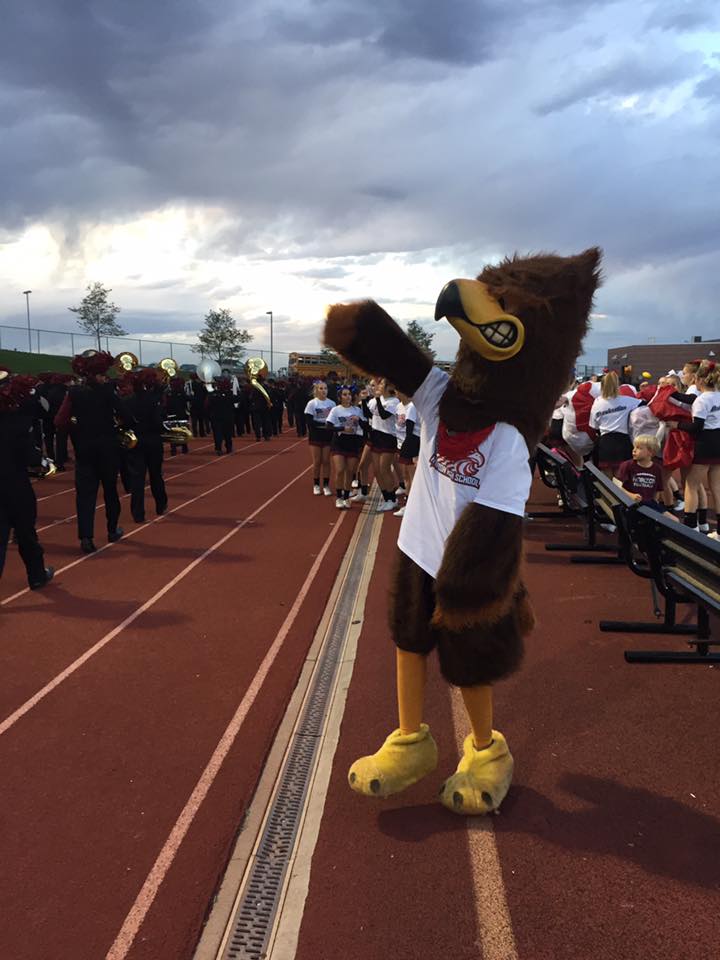 Huey the Hawk showing off their school spirit at the USA themed football game.