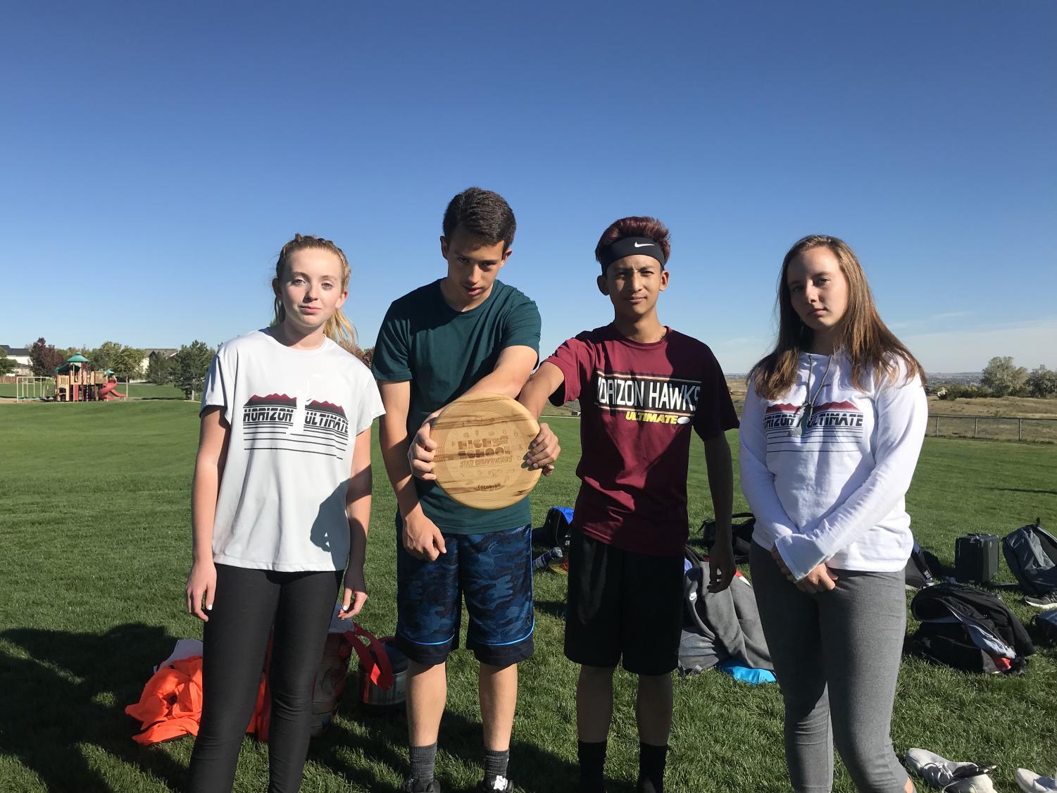 Madison Endicott (10) - Junior Captain, Samuel Ruiz-Harding (10) - Junior Captain, Ethan Tran (10) - Head Captain, and Emily Dhainin (12) - Head Captain pose with their Spirit Award which they won during the 2017-2018 season