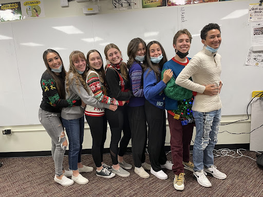 HHS Stugo shows off their ugly sweaters on Thursday for an “awkward family photo” vibe. 