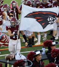 #17 on Horizon’s football team carrying their school flag.