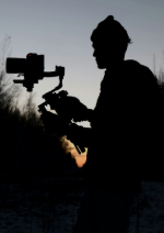 Man filming on a camera.